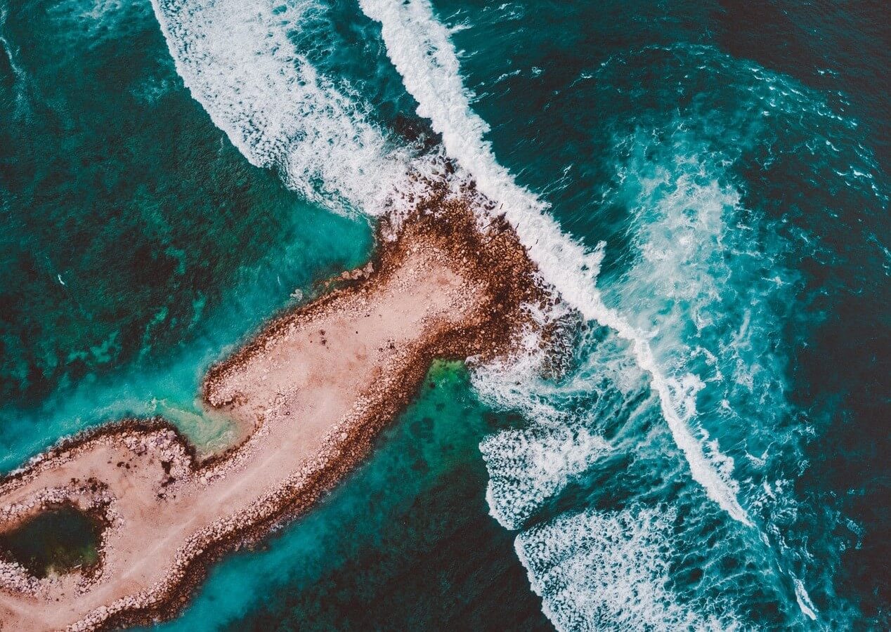 sand rock island deep green sea